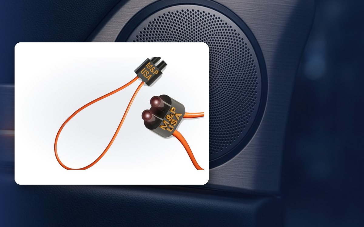 M&P USA MOST fiber optic bypass loop in front of a car door speaker
