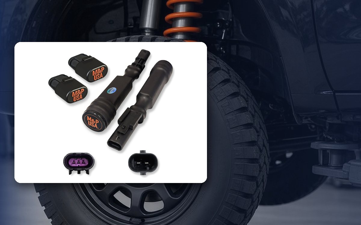 M&P USA Z95 MagneRide bypass kit in front of a lifted black SUV with orange coilovers
